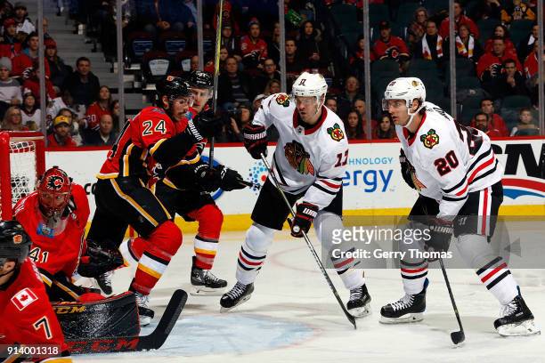 Lance Bouma and Brandon Saad of the Chicago Blackhawks skate against the Calgary Flames during an NHL game on February 3, 2018 at the Scotiabank...