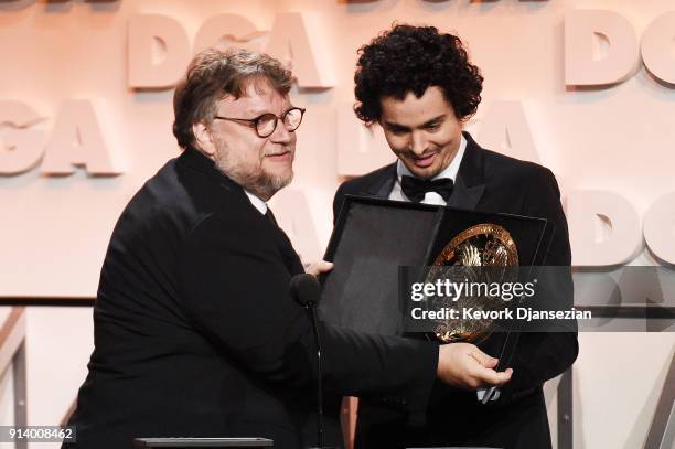 Director Guillermo del Toro accepts the award for Outstanding Directorial Achievement in Feature Film for 'The Shape of Water' from director Damien...