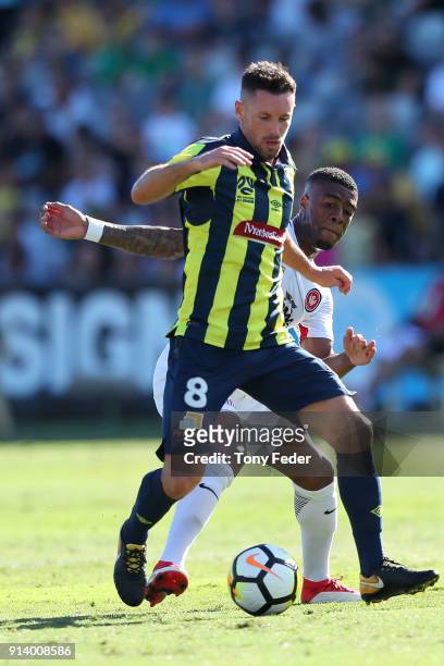 Blake Powell of the Mariners contests the ball with Rolieny Bonevacia of the Wanderers during the round 19 A-League match between the Central Coast...