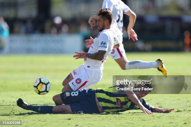 Blake Powell of the Mariners contests the ball with Brendan Hamill of the Wanderers during the round 19 A-League match between the Central Coast...