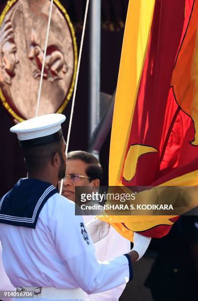 Sri Lankan President Maithripala Sirisena hoists the national flag during Sri Lanka's 70th Independence Day celebrations in Colombo on February 4,...