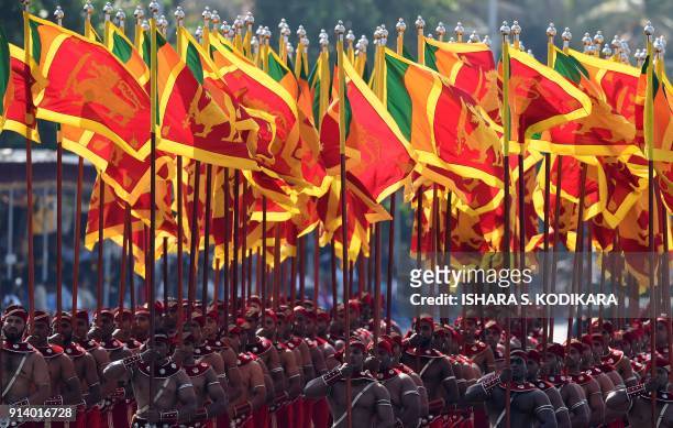 Sri Lankan military personnel march with the national flag during Sri Lanka's 70th Independence Day celebrations in Colombo on February 4, 2018. -...