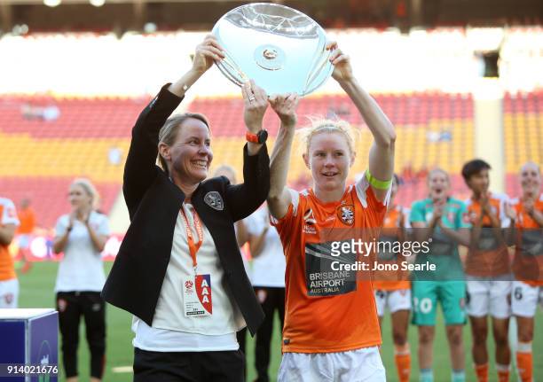 Brisbane coach Melissa Andreatta and captain Clare Polkinghorne celebrate with the premiership trophy after the win during the round 14 W-League...