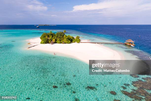 aerial view of couple on a beach, maldives - island hut stock pictures, royalty-free photos & images