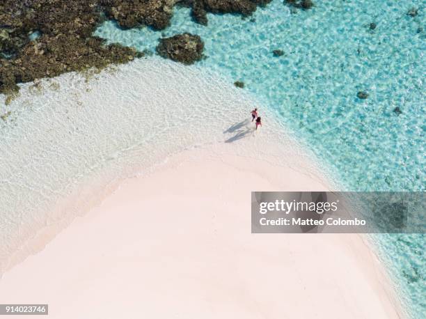 overhead view of couple on a beach, maldives - people aerial view beach stock pictures, royalty-free photos & images