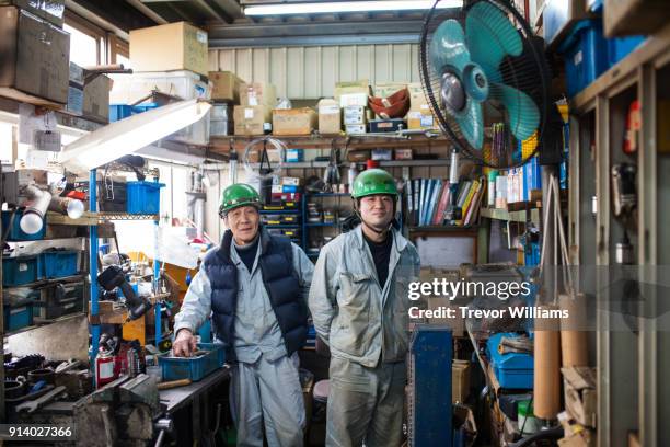 father and son steel workers together in the shipbuilding industry - coveralls ストックフォトと画像