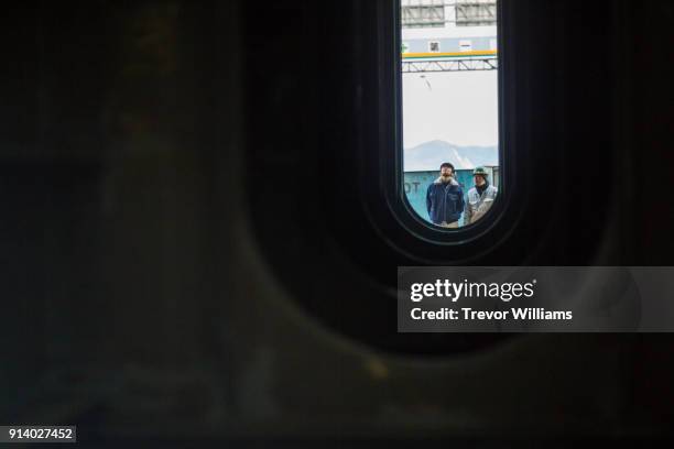 two engineers inspecting parts of a cargo ship at a shipbuilding yard - ship building stockfoto's en -beelden