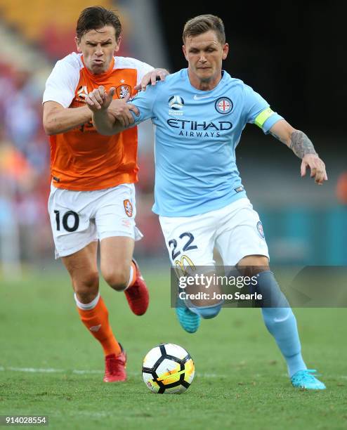 Brisbane player Brett Holman and Melbourne player Michael Jakobsen compete for the ball during the round 19 A-League match between the Brisbane Roar...