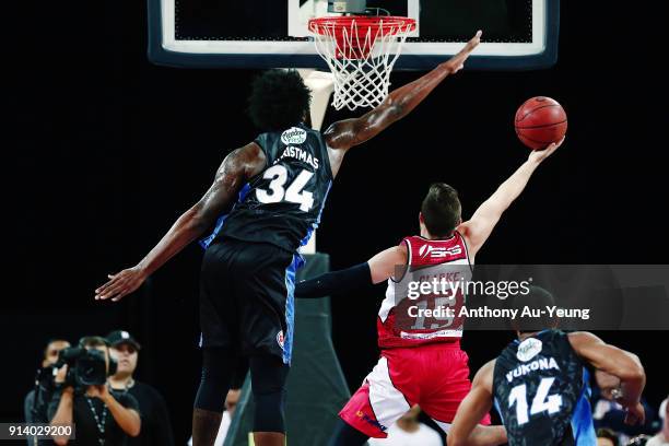 Rakeem Christmas of the Breakers goes for the block on Rotnei Clarke of the Hawks during the round 17 NBL match between the New Zealand Breakers and...