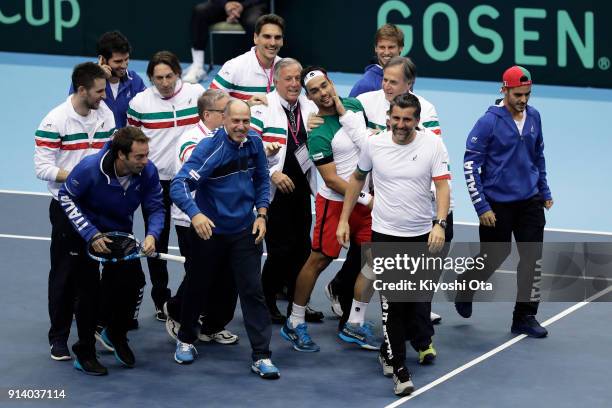 Fabio Fognini of Italy celebrates the team's 3-1 victory with his team mates and team staff after winning his singles match against Yuichi Sugita of...