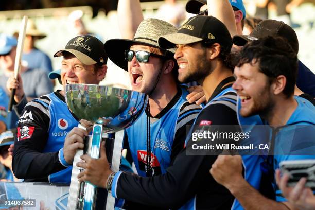 Colin Ingram and Wes Agar of the Strikers pose with the trophy and supporters after the Big Bash League Final match between the Adelaide Strikers and...