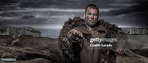 hammer wielding viking warrior brunette male in wild highland countryside - chain mail textile stock pictures, royalty-free photos & images