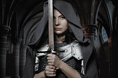 Sword wielding viking warrior dark haired female in wild highland countryside