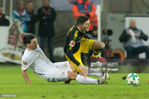 Milos Jojic of Koeln and Christian Pulisic of Dortmund battle for the ball during the Bundesliga match between 1. FC Koeln and Borussia Dortmund at...