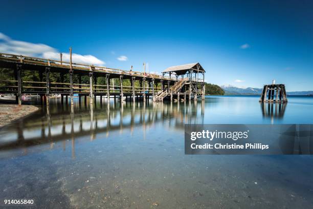 pier with crystal clear water in argentina - villa-la-angostura stockfoto's en -beelden