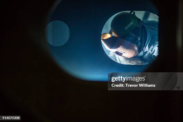 a steel worker welding together a ship in a shipbuilding factory - ship builders stock pictures, royalty-free photos & images