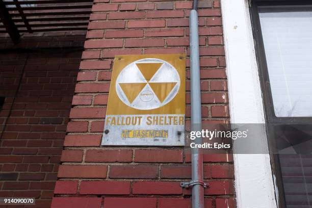 Sign for a nuclear fall out shelter outside a residential block in Brooklyn for a nuclear fall out shelter which is located in the basement.