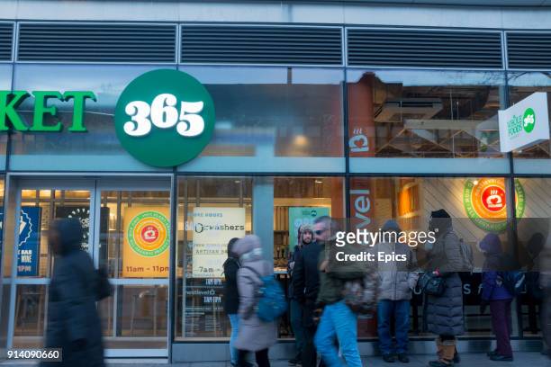 People queue in line in front of the new Whole Foods 365 store on Flatbush Avenue Brooklyn - the grocery store will be the first Whole Foods 365 to...