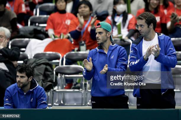 Simone Bolelli, Thomas Fabbiano and Paolo Lorenzi of Italy cheer for Fabio Fognini of Italy as they watch his singles match against Yuichi Sugita of...