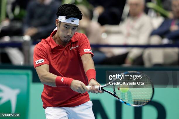 Yuichi Sugita of Japan plays a backhand in his singles match against Fabio Fognini of Italy during day three of the Davis Cup World Group first round...