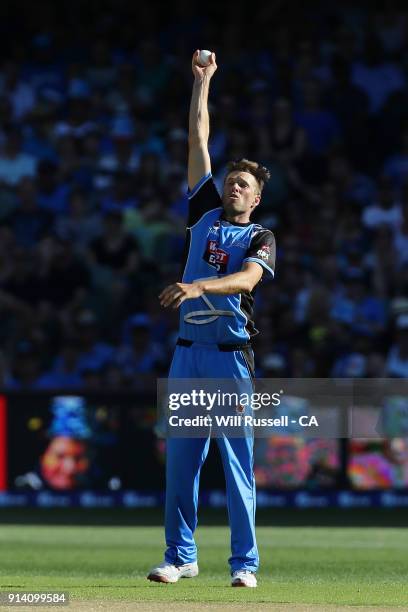 Ben Laughlin of the Strikers fields off his own bowling during the Big Bash League Final match between the Adelaide Strikers and the Hobart...