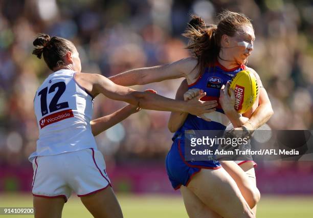 Tiarna Ernst of the Bulldogs is tackled by Ebony Antonio and Ashlee Atkins of the Dockers during the 2018 AFLW Round 01 match between the Western...