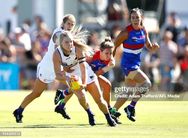 Hayley Miller of the Dockers is tackled by Angelica Gogos of the Bulldogs during the 2018 AFLW Round 01 match between the Western Bulldogs and the...