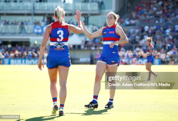 Isabel Huntington of the Bulldogs high fives Katie Brennan of the Bulldogs on the 3 quarter time siren during the 2018 AFLW Round 01 match between...