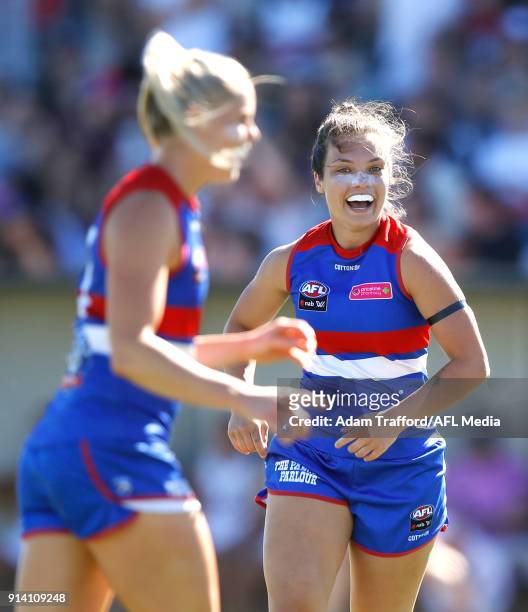 Ellie Blackburn of the Bulldogs runs in to congratulate Katie Brennan of the Bulldogs on a goal during the 2018 AFLW Round 01 match between the...