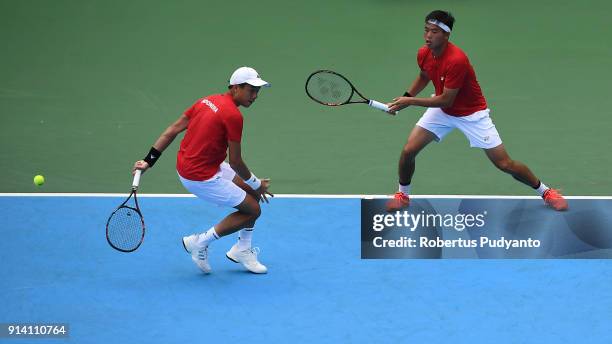 Justin Barki and David Agung Susanto of Indonesia compete against Francis Casey Alcantara and Jurence Zosimo Mendoza of Philippines during the first...