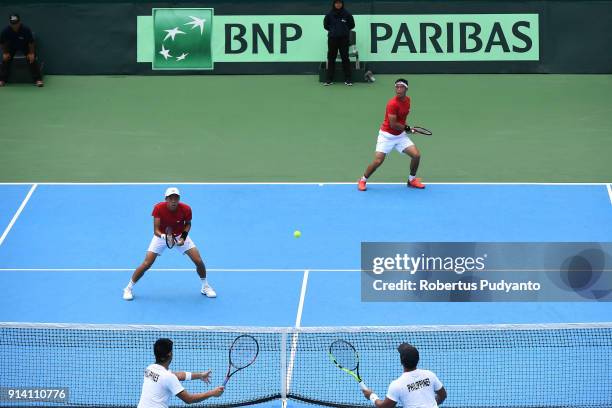 Justin Barki and David Agung Susanto of Indonesia compete against Francis Casey Alcantara and Jurence Zosimo Mendoza of Philippines during the first...