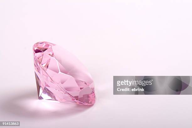 single pink diamond on white background copyspace right - diamond gemstone stock pictures, royalty-free photos & images