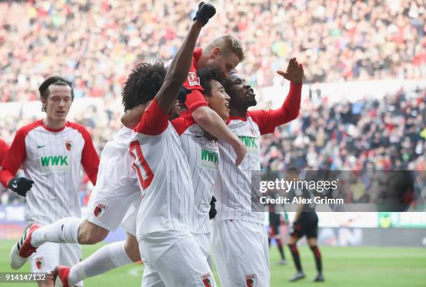 Ja-cheol Koo of Augsburg celebrates his team's first goal with team mates Kevin Danso , Martin Hinteregger and Caiuby during the Bundesliga match...