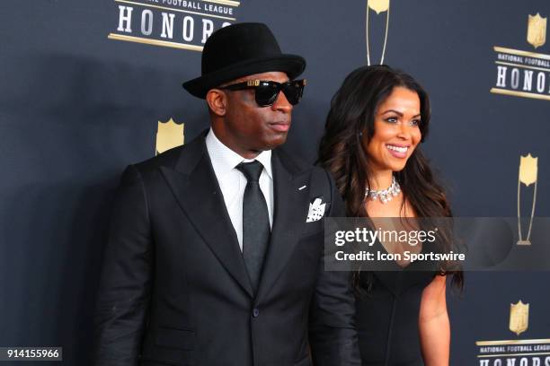 Deion Sanders and Tracey Edmonds pose for photographs on the Red Carpet at NFL Honors during Super Bowl LII week on February 3 at Northrop at the...