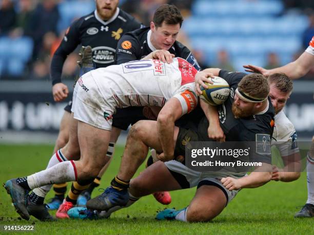 Tom West of Wasps tackled by George Worth of Leicester Tigers during the Anglo-Welsh Cup match between Wasps and Leicester Tigers at Ricoh Arena on...