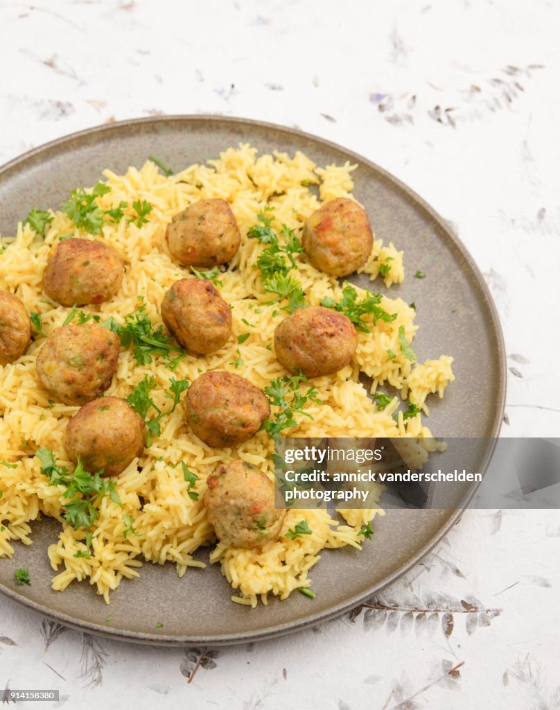 Vegetarian vegetable balls on yellow rice.