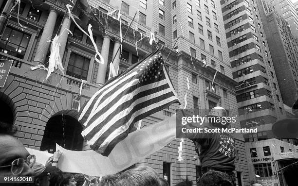New York - A construction worker, and war veteran proudly raises an American flag along Broadway's Canyon of Heroes during a parade honoring Vietnam...