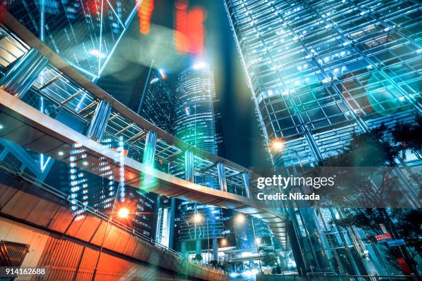 stock market exchange data on skyscraper in hong kong - china international exhibition centre stock pictures, royalty-free photos & images