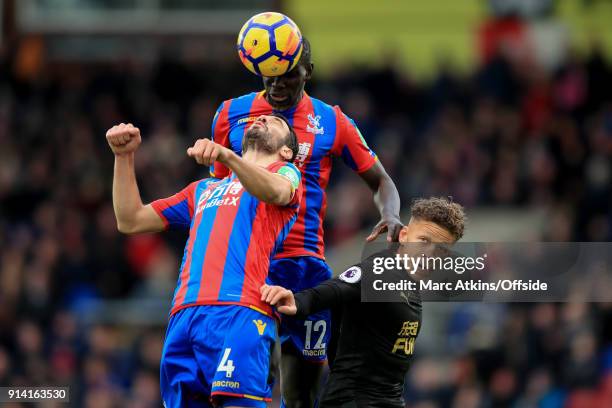 Bakary Sako and Luka Milivojevic of Crystal Palace in action with Dwight Gayle of Newcastle United during the Premier League match between Crystal...