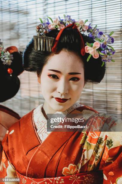 portrait of a maiko girl looking in camera - geisha in training stock pictures, royalty-free photos & images