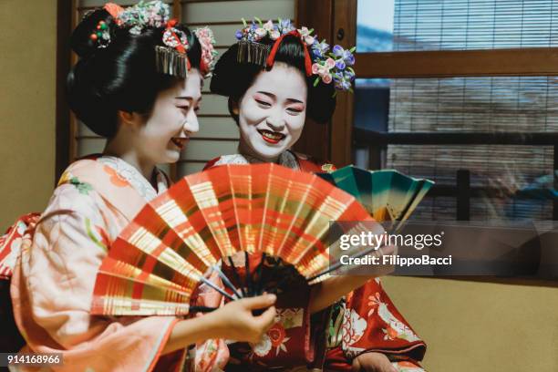 maiko women together in kyoto - geisha in training stock pictures, royalty-free photos & images