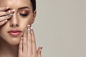 Stylish manicure and make up in a pale-pink color.