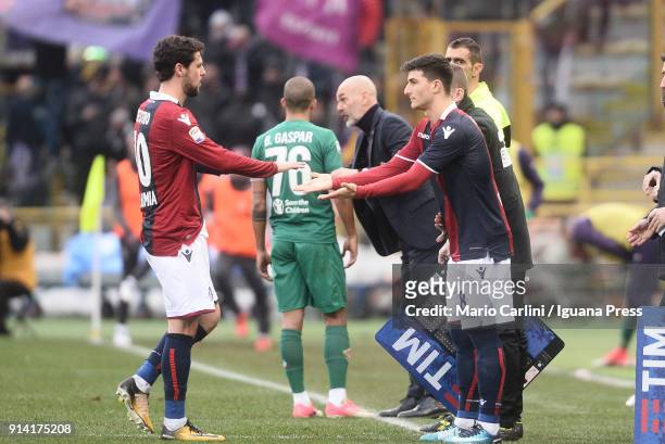 Riccardo Orsolini of Bologna FC shakes hands with Mattia Destro when called for a substitution during the serie A match between Bologna FC and ACF...