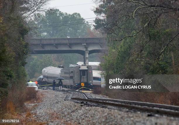 Derailed Amtrak car can be seen up the tracks near a crossing after an early morning collision with a CSX freight train on February 4, 2018 in Cayce,...