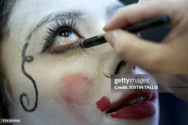 Clown is made up ahead of the annual Grimaldi Memorial Service at the All Saints church in east London on February 4, 2018. The service takes place...