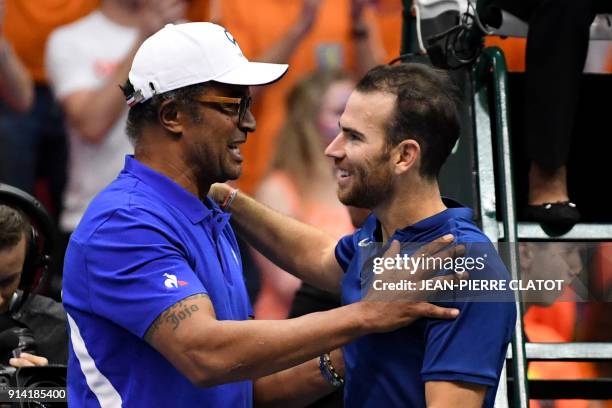 France's Adrian Mannarino reacts with France's team captain Yannick Noah after winning his singles tennis match against the Netherlands' Robin Haase...