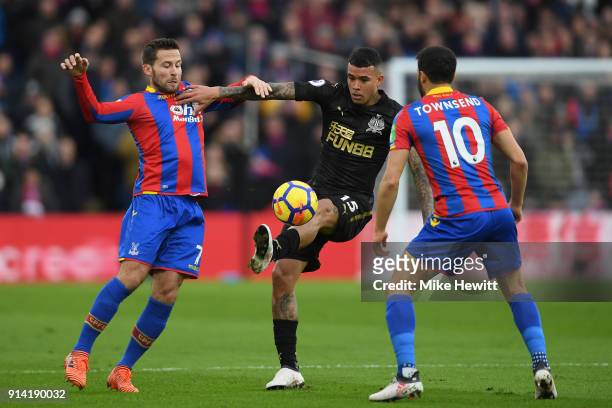 Kenedy of Newcastle United is challenged by Yohan Cabaye and Andros Townsend of Crystal Palace during the Premier League match between Crystal Palace...