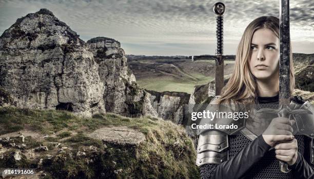 sword wielding viking warrior young blond female in wild highland countryside - viking warrior stock pictures, royalty-free photos & images