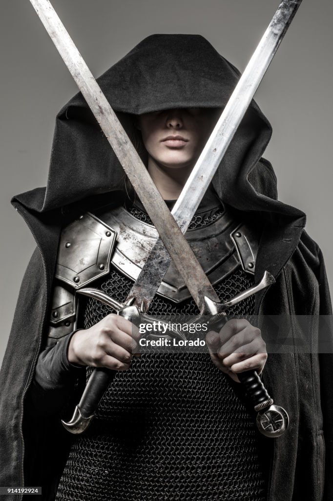 Sword wielding viking warrior young blond female in studio shot