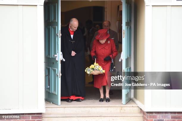 Queen Elizabeth II and The Duke of Edinburgh leave with Reverend Jonathan Riviere after attending St Peter and Paul Church in West Newton, Norfolk,...